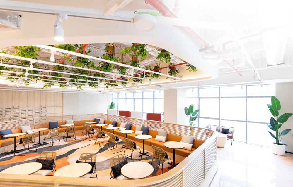 Modern office space in Jakarta with professional team working on laptops and technology